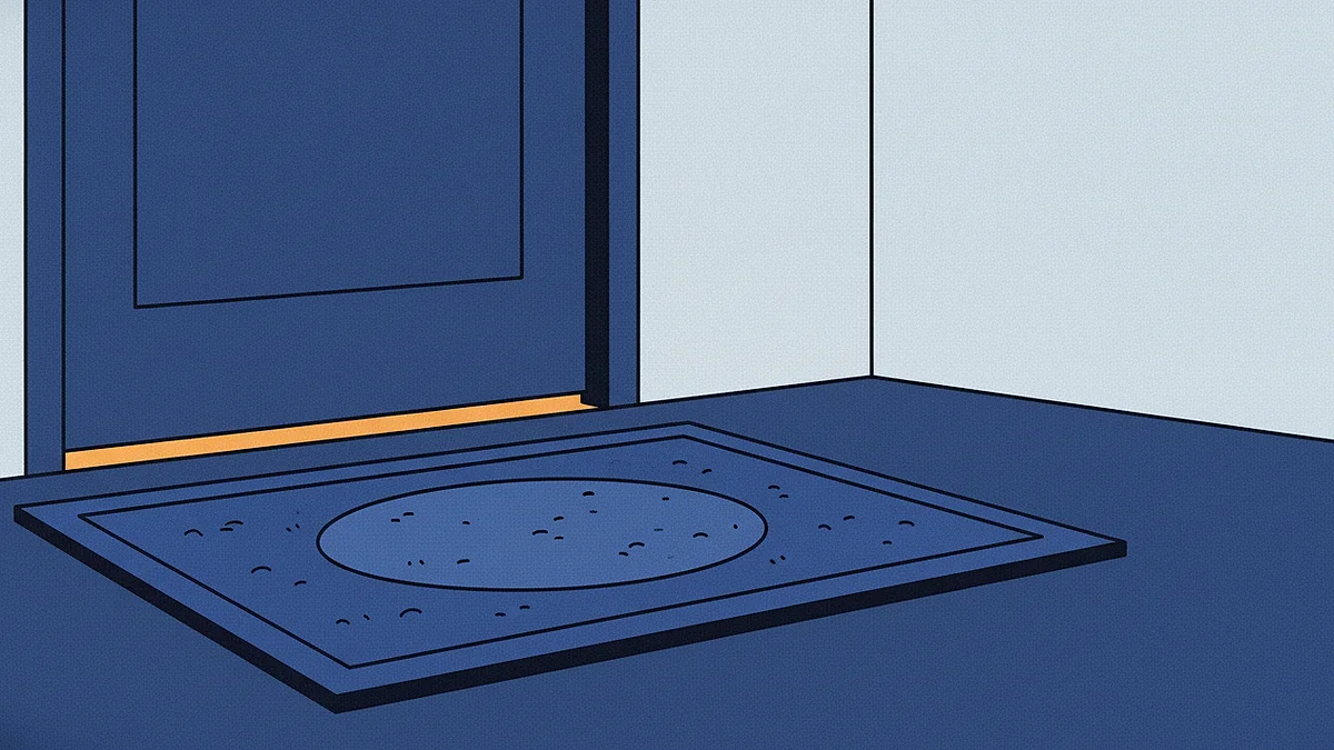 A doormat worn thin in one spot in front of a closed door, warm light showing in the gap underneath.